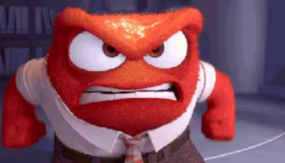 a red cartoon character with a white shirt and tie is making an angry face .