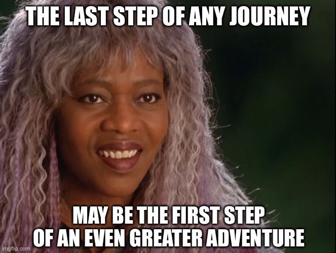 A scene from Disney’s 2003 television movie adaptation of A Wrinkle in Time shows Mrs. Which, played by Kate Nelligan, smiling with long silver-purple hair and a gentle expression. She is one of the three celestial guides who help the main characters on their journey through space and time. Overlaid text at the top reads, “THE LAST STEP OF ANY JOURNEY” and at the bottom, “MAY BE THE FIRST STEP OF AN EVEN GREATER ADVENTURE.” The quote reflects the movie’s message about endings leading to new beginnings.