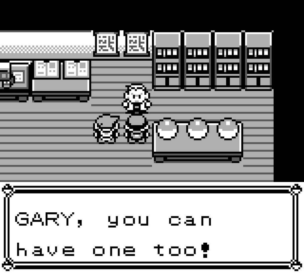 Screenshot from Pokémon Red. Inside Professor Oak’s lab, the player character and their rival Gary stand in front of a table with three Poké Balls. Professor Oak stands behind the table, saying, “GARY, you can have one too!” The lab features bookshelves, machines, and charts on the walls, all in black and white pixel art.