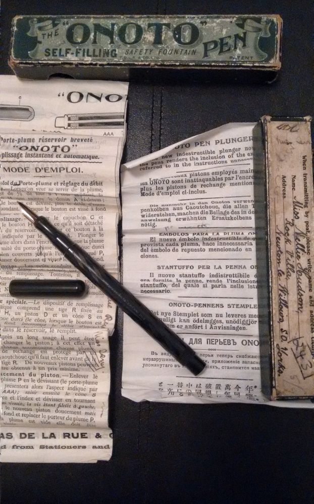 Onoto model N in black chased ebonite, plunger-filler, early overfeed system, pictured with original box and notices (one in several languages including Russian and Japanese)