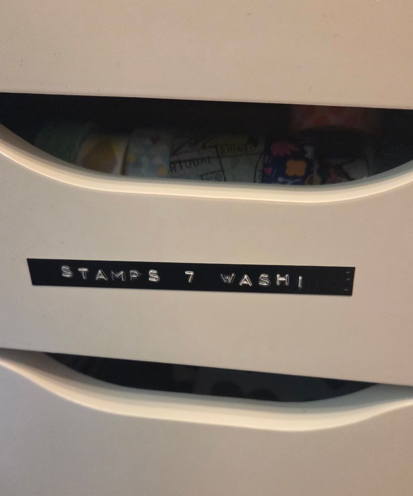 A white drawer with a black and white embossed label that says "STAMPS 7 WASHI" in all caps.