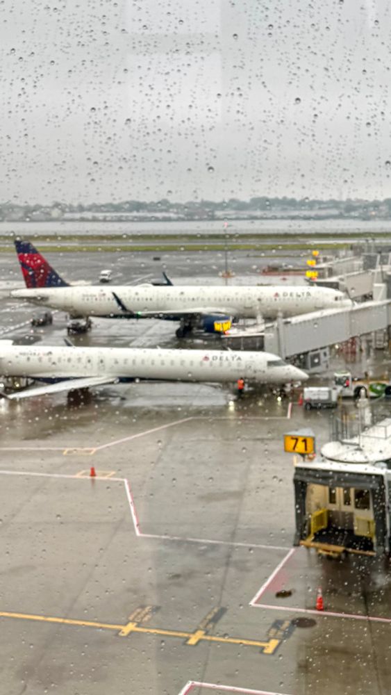 Aircraft seen through a rain-wet window 