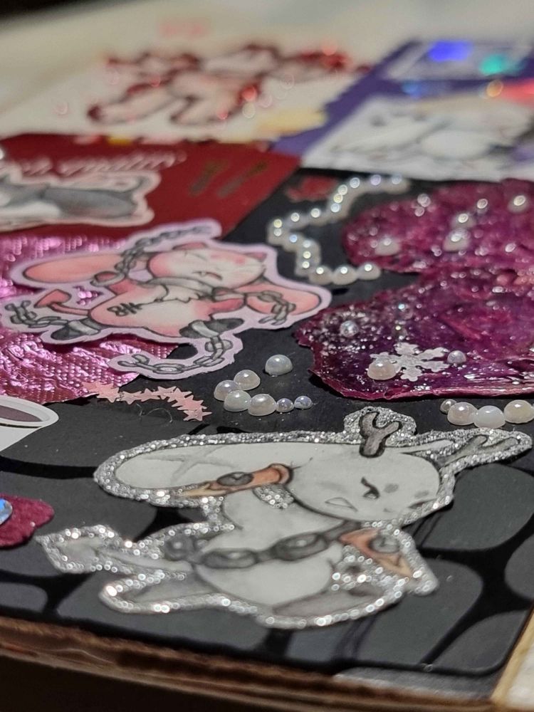 Close up photo of a vampire hunter character with real rose petals and pearls glued in a pretty composition.