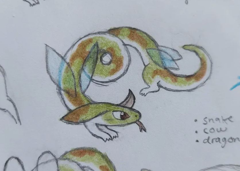 A drawing on paper depicting a creature that looks like a snake with a singular horn and big, droopy cow-like ears. It's green with a white underbelly and it has brown spots like a cow. There are two pair of blue translucent bug wings and it has small legs and arms.