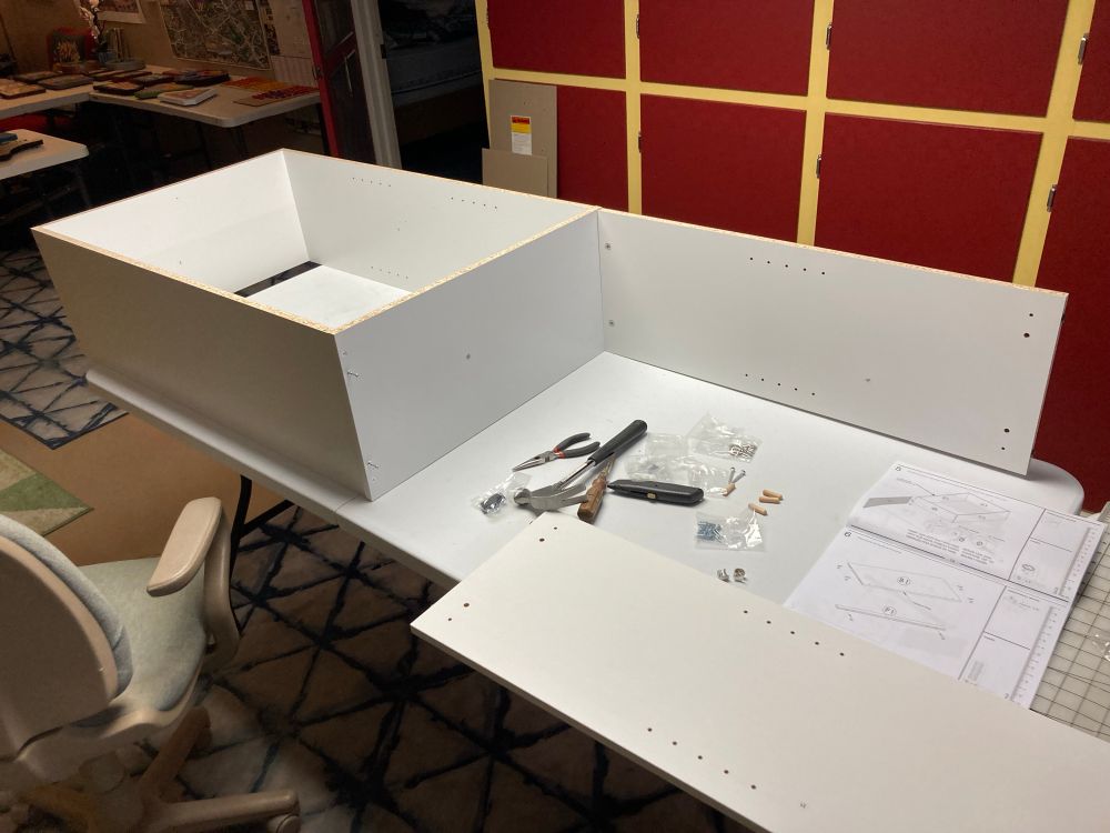 A half-assembled cheapo bookcase that is taking way too long to assemble because all the holes are misaligned. You get what you pay for! 