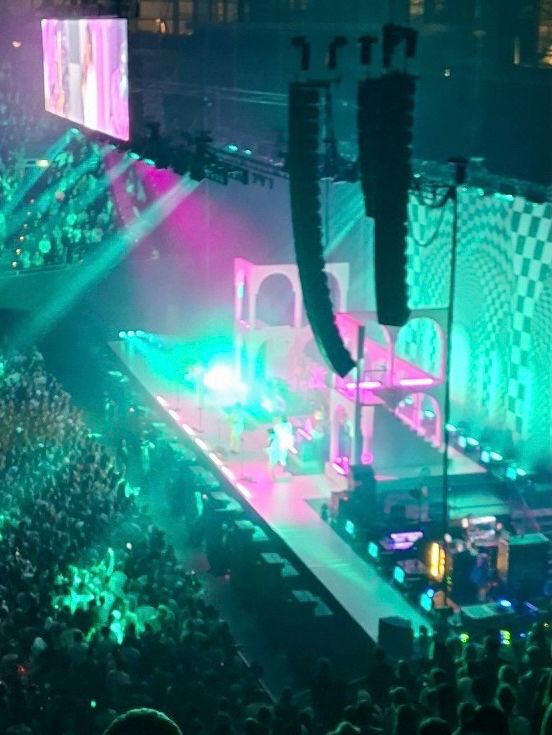 Näherer Ausschnitt des vorherigen Fotos: Bühne Olympiahalle München mit Türkiser Lichtshow und pinken Elementen.