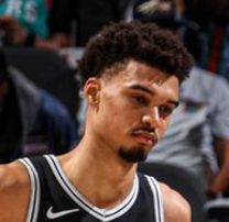 Close up of Wembe's face looking bored and annoyed.