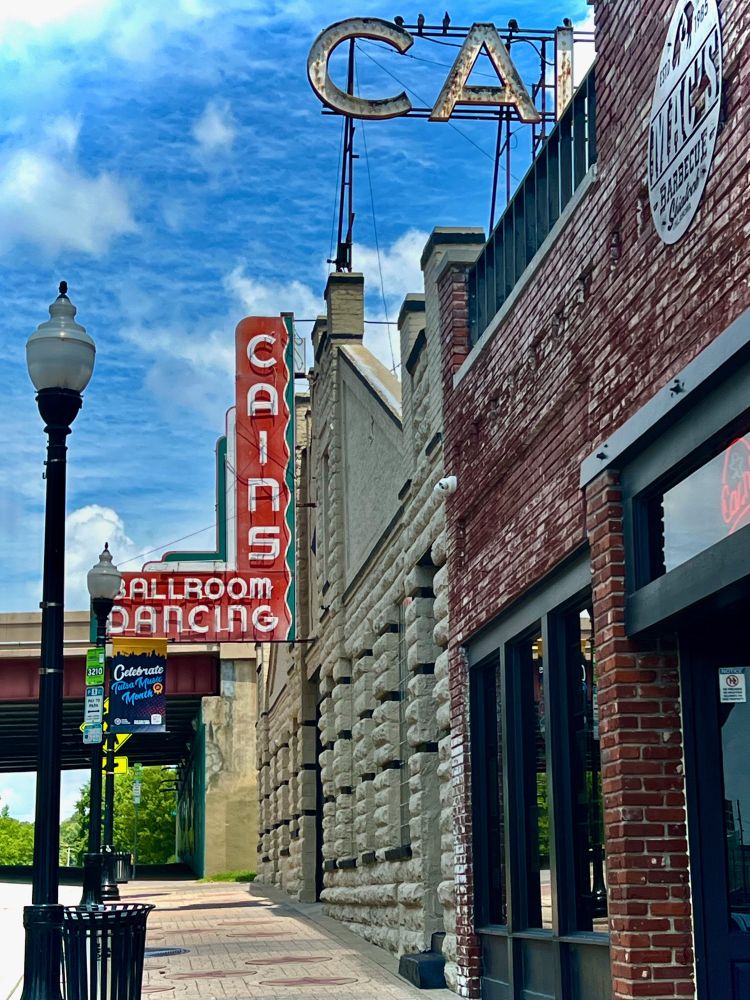 sidewalk view of Cains Ballroom, Tulsa against a blue sky