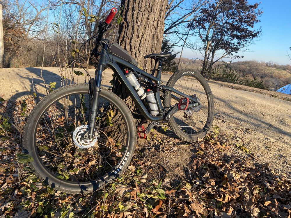Bike leaning up against a tree on a crisp early winter day