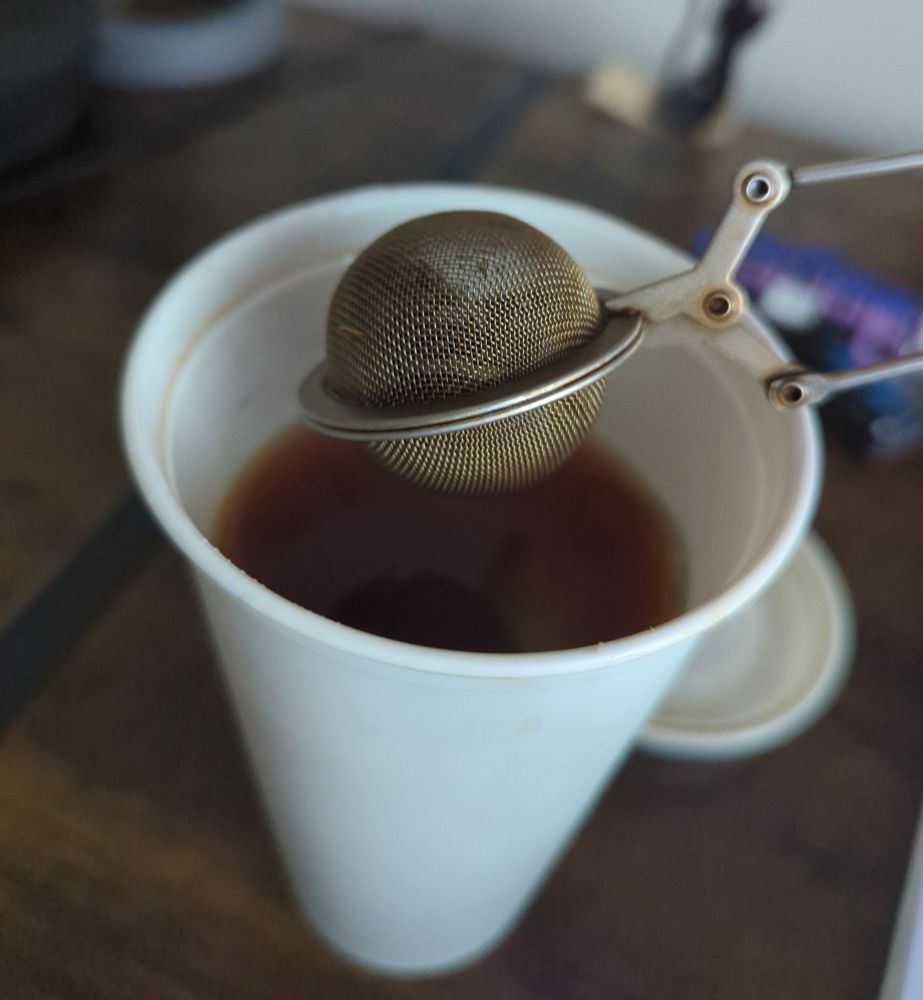 Starbucks plastic cup with ball of tea coming out of it 