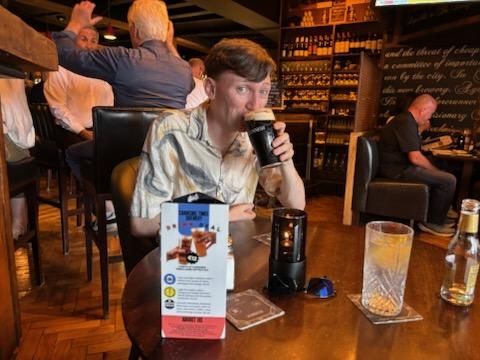 The writer's son drinking a Guinness inside an Irish pub 