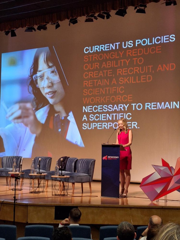 Photo. Slide says "current us policies strongly reduce our ability to create, recruit and retain a skilled scientific workforce"