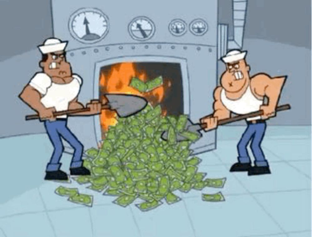 two men are shoveling a pile of money into a fireplace .