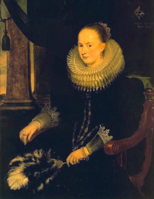 The portrait depicts Antonia Canis, a woman of the wealthy Antwerp burgher class, seated and holding a feathered fan. She is dressed in a dark, rich gown, characteristic of 17th-century Baroque fashion, featuring a prominent, intricately ruffled white ruff collar and delicate lace cuffs. A pearl necklace and earrings adorn her. Antonia Canis is shown with a reserved yet dignified expression, looking directly at the viewer. 