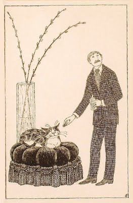 Illustration of a man, dressed in a full tweed suit, standing next to a cat sitting on a round, cushioned ottoman. The man is leaning slightly towards the cat and appears to be offering it a small item, possibly food or a treat, which he holds between his fingers. In the background to the left, a tall, clear vase holds several branches of pussy willows.
