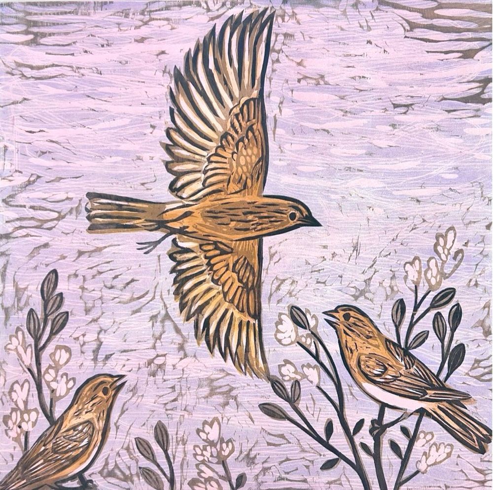 One bird in flight above two birds singing in a tree, pink dawn sky background. Woodcut.