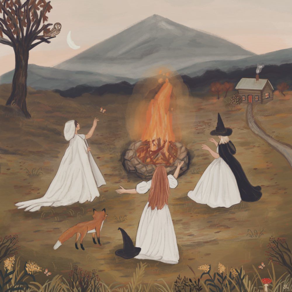 A painting of three women gathered around a campfire in a natural. The three women are in long white dresses. One woman on the left, in a white hood/cloak, is reaching towards a butterfly.
The central woman, seen from behind with long reddish hair, has her arms outstretched towards the fire. The woman on the right wears a black witch's hat and a black cloak over her white dress, also gesturing towards the fire.
A fox is standing near the woman on the left, and a black witch's hat is on the ground near the central woman. The background features a large, grey mountain and rolling hills under an evening sky with a crescent moon and an owl perched on a bare tree branch.
A small, rustic cabin with smoke coming from the chimney is visible in the distance on the right, connected by a dirt path. The foreground is filled with grass, small plants, mushrooms, and a few butterflies.