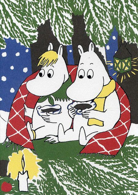 Illustration of Snorkmaiden and Moomintroll sitting close together outdoors in a snowy environment, surrounded by pine trees under falling snow. They are wrapped in a red blanket with a white checked pattern and are holding cups with hot beverages. A lit candle sits in the foreground, and a lit lantern hangs from a tree branch in the background.