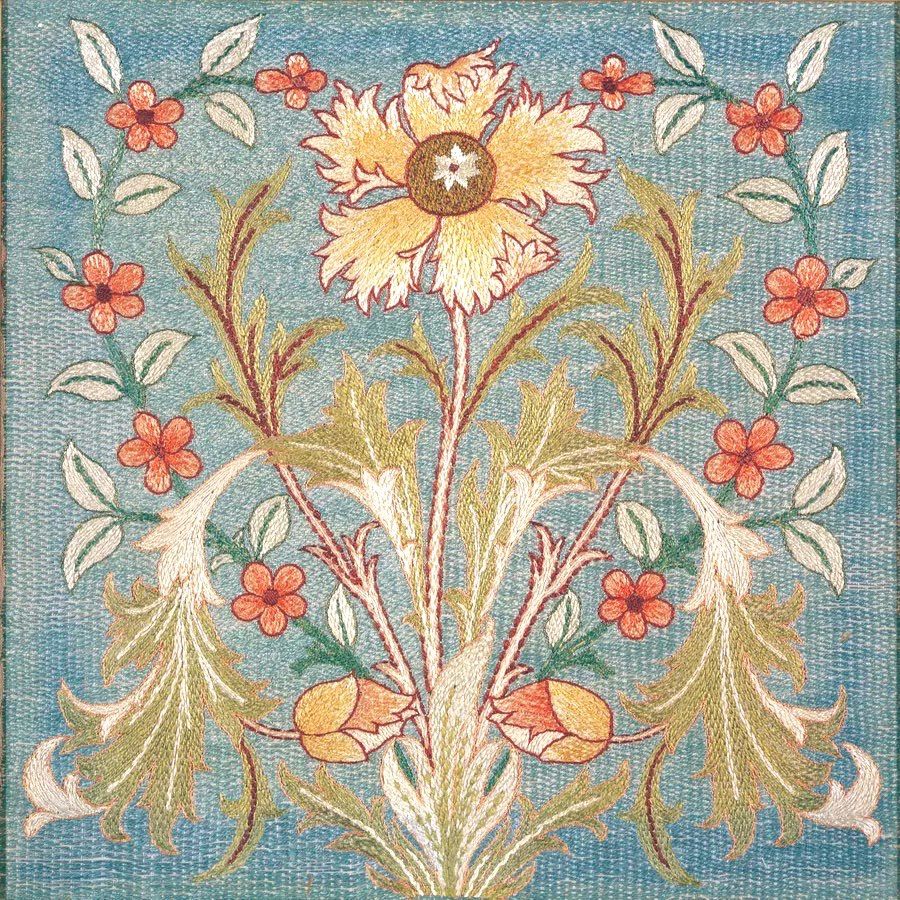 A large yellow and orange flower with intricate, fringed petals dominates the center. The central flower is flanked by symmetrical, flowing acanthus-like leaves in shades of green, gold, and white, with reddish-brown stems. A border of small, simple orange-red flowers and white leaves frames the main composition against a textured, duck-egg blue background.
