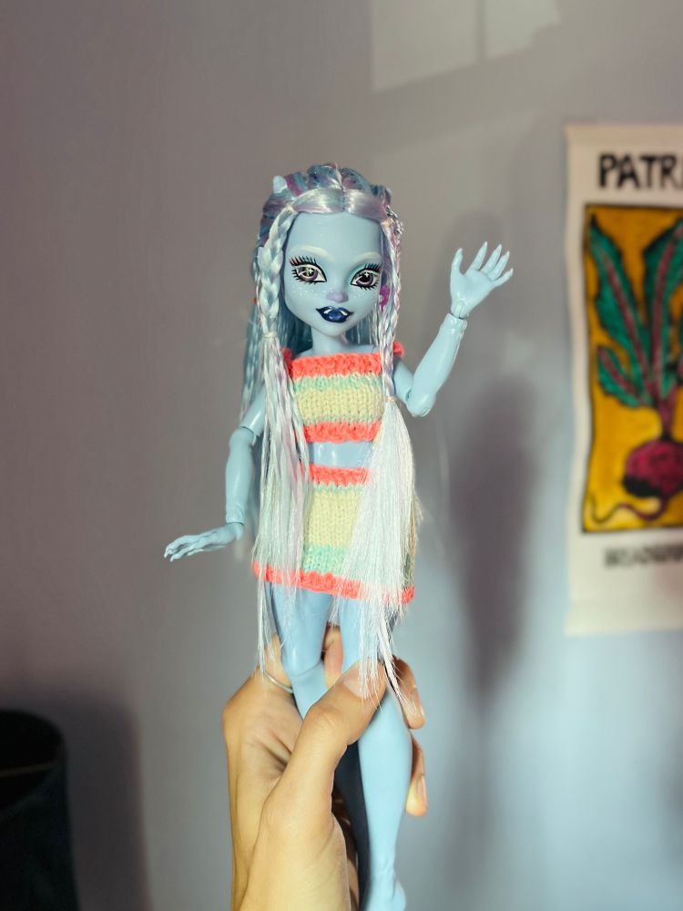 monster high abbey doll with hair braided to frame her horns and eyebrows repainted in white