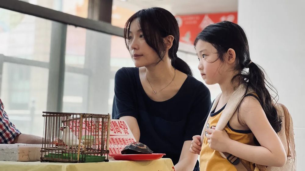 Janel Tsai (left) and Shih-Yuan Ma (right) listen intently to a conversation in a still from Shih-Ching Tsou’s LEFT-HANDED GIRL. 