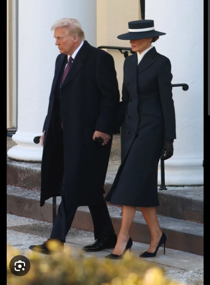 Spy vs Spy cartoon with black Spy carrying a round bomb with the fuse burning. 