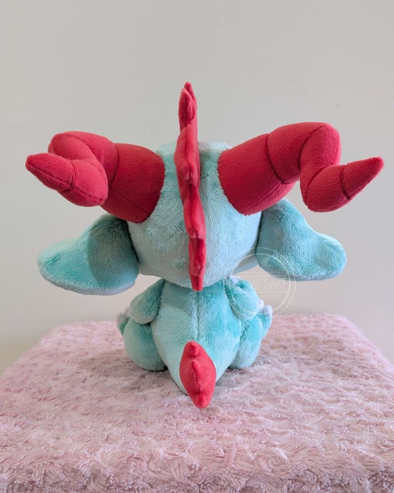 Back view of the green dragon plushie.
