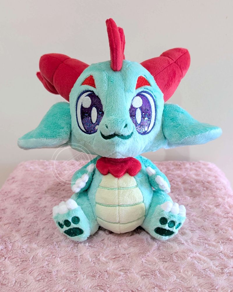 Front view of the green dragon plushie.