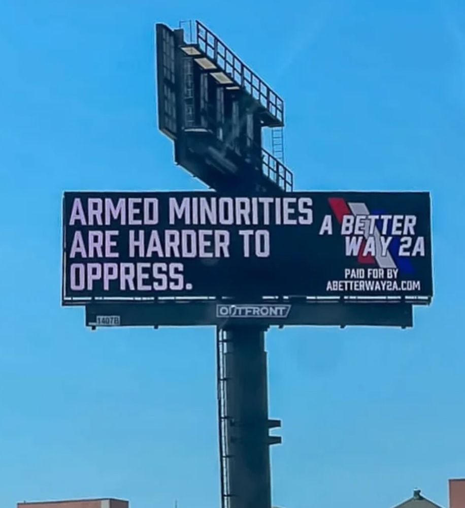 A billboard that says "Armed minorities are harder to oppress". 