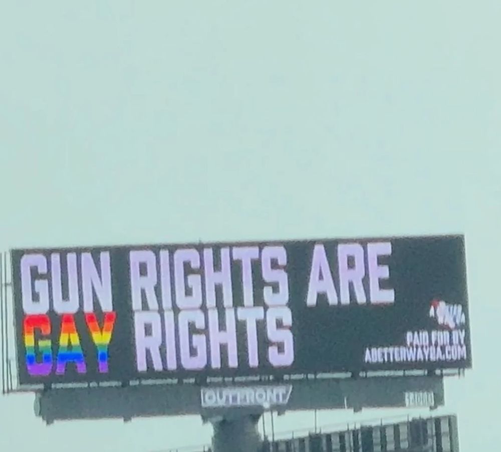 A billboard that says "Gun rights are gay rights". 
