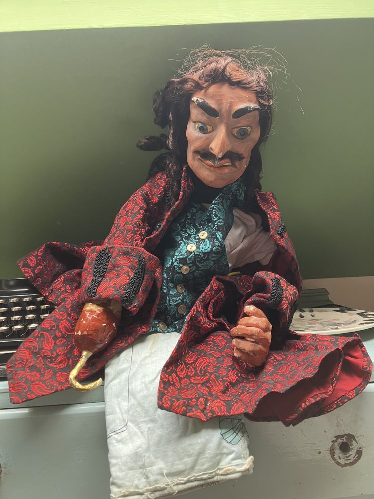 A puppet of Captain Hook, with a red coat and green waistcoat