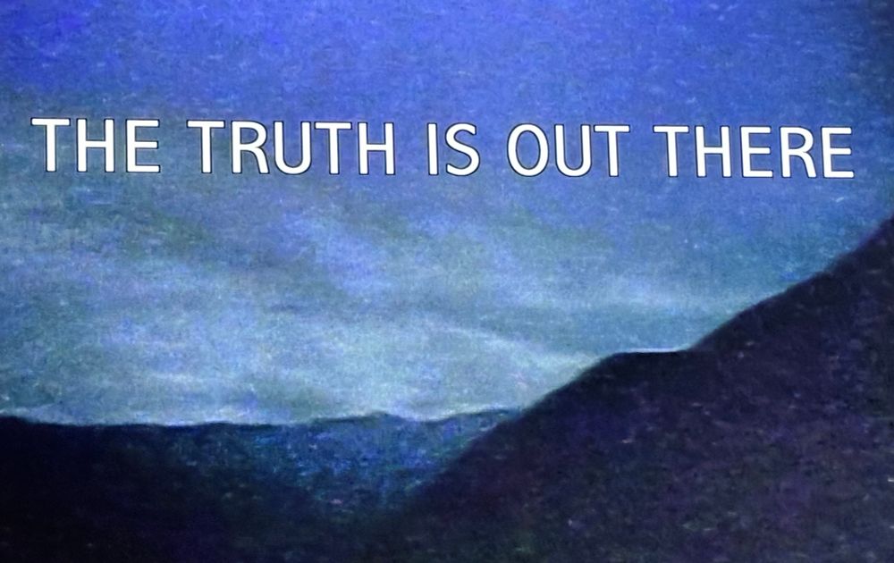Grainy shot of the x files open saying 

THE TRUTH IS OUT THERE