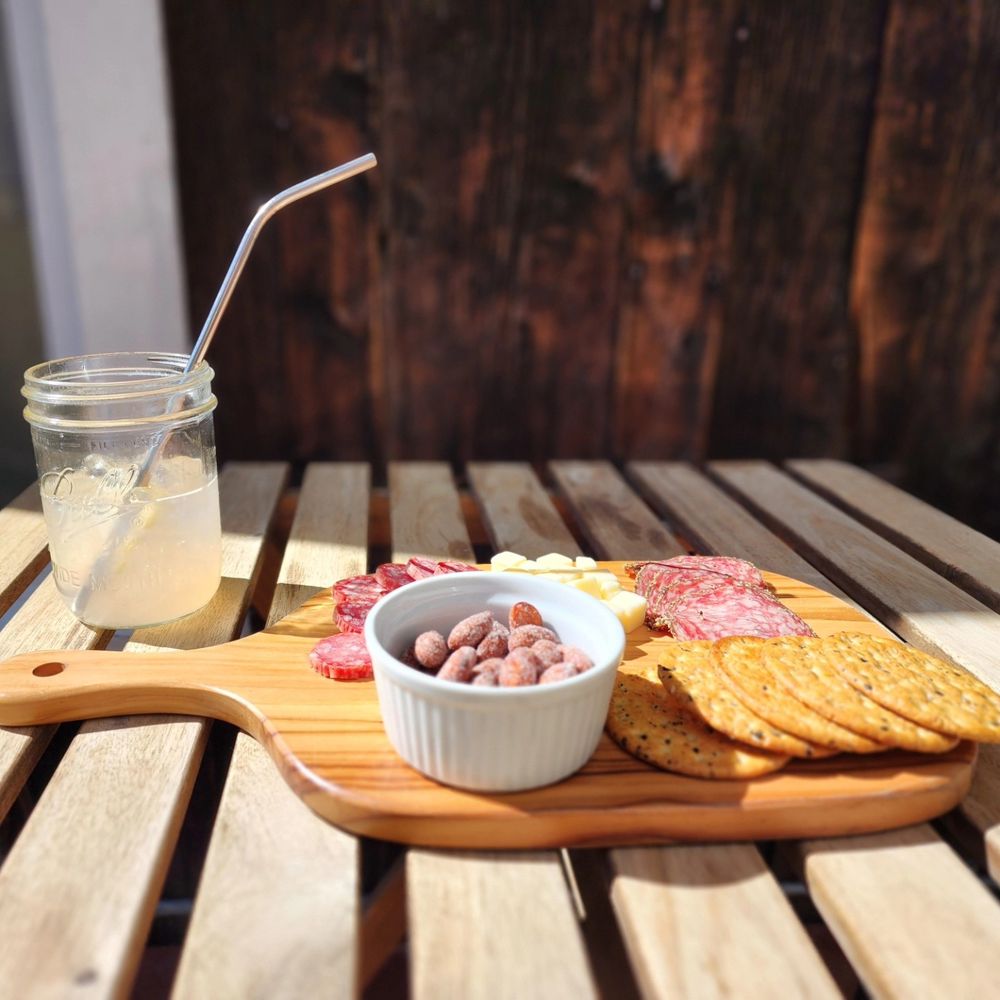 Outdoor lunch (freezing my butt off) of just a charcuterie board, some meats, cheeses, crackers and a sparkling lemonade