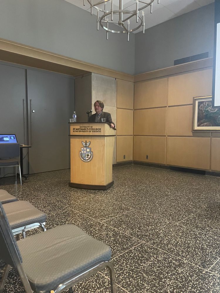 Stuart Carroll speaking at a lectern