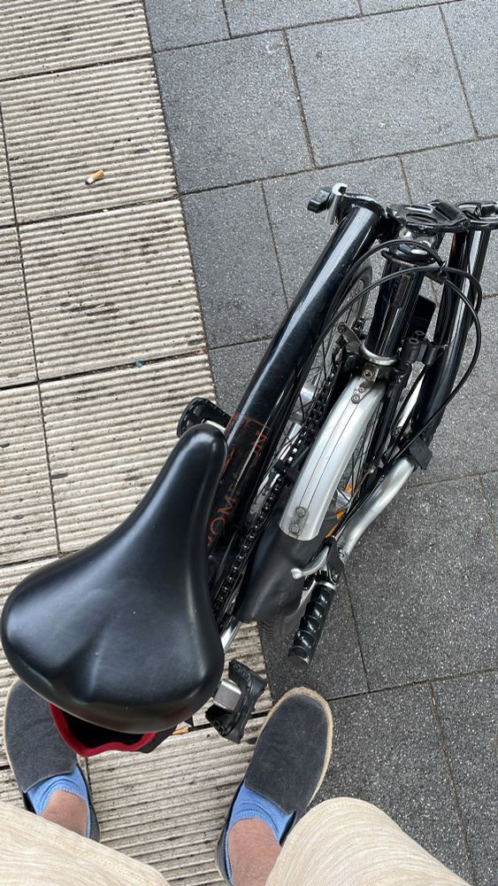 My feet and my folded Brompton 