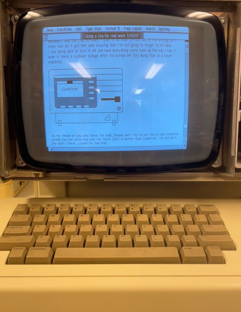 close up of document written in Lisa Write.file name is "Using a Lisa for real work 3/30/07." includes a graphic that's an outline of the front of an Apple Lisa with "LisaWrite" appearing in the center of the screen.
