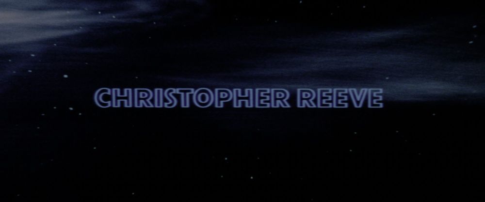 Still from the Superman (1978) opening titles. The text "Christopher Reeve" appears on a starfield.