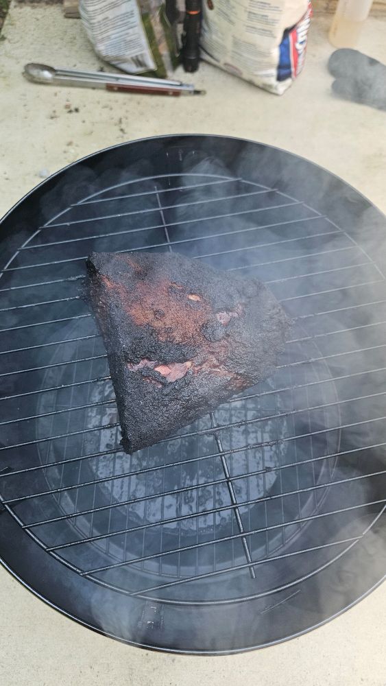 A half of a brisket flat in a smoker