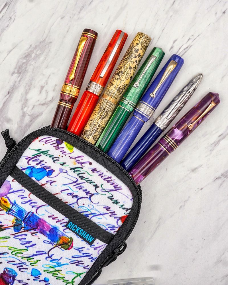 Fountain pens in every color of the rainbow emerging from a multicolored pen case