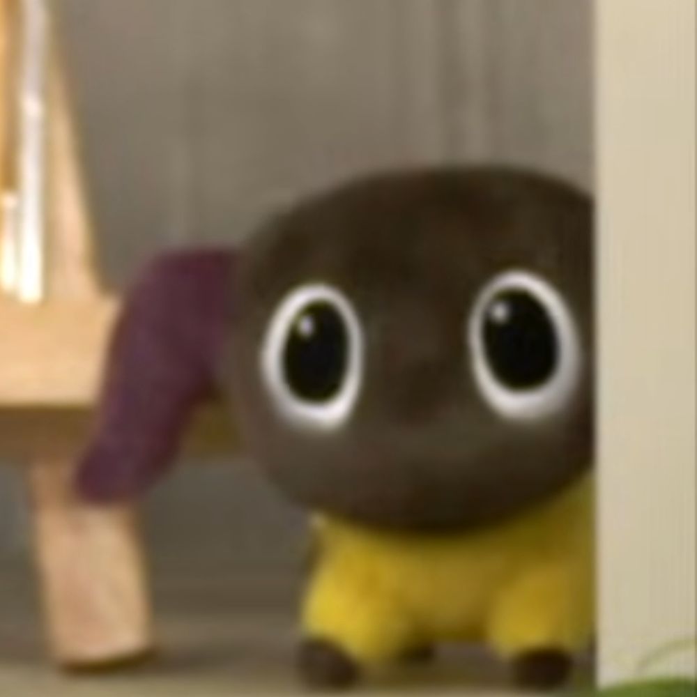 an innocent little tank buster yan plush staring menacingly from the background of a video