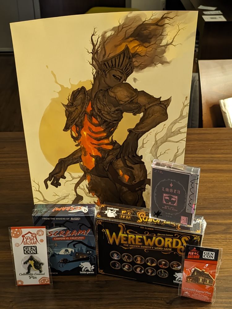 a picture of Were words and SCREAM! games, a large print of an infernal dryad, a cassette tape and two pins