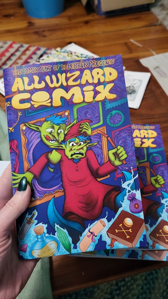 Cover of the anthology, featuring a bunch of framed portraits and one of them has a wizard pulling in another wizard that looks exactly like it.