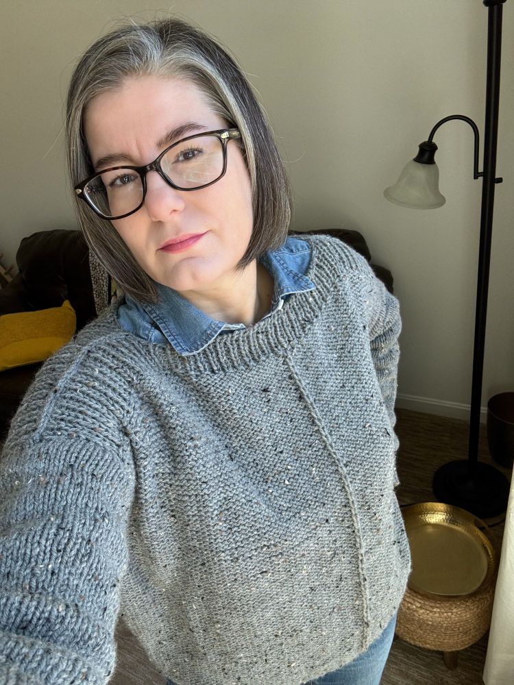 Woman wearing a gray handknit sweater