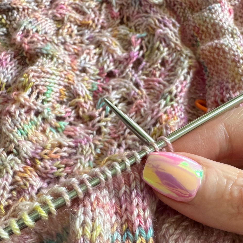 Work in progress handknit top from pink multicolored yarn