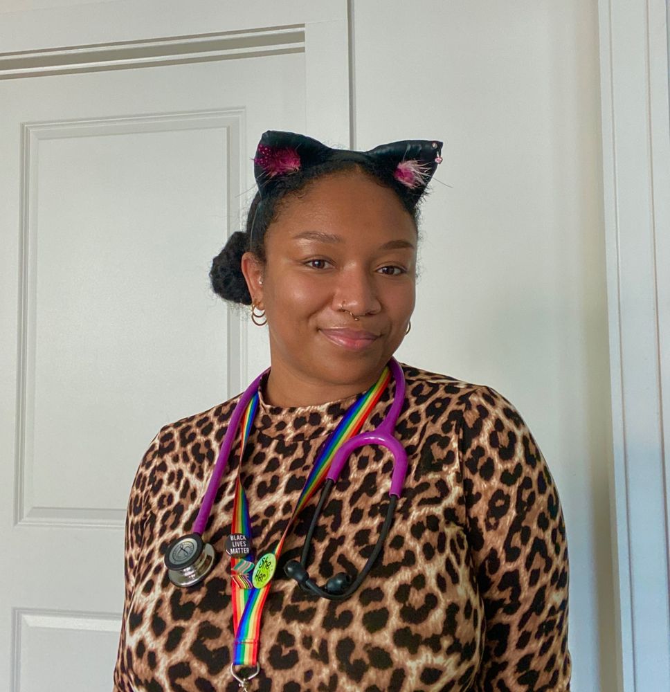 Your favorite pediatrician wearing cat ears and a leopard print shirt