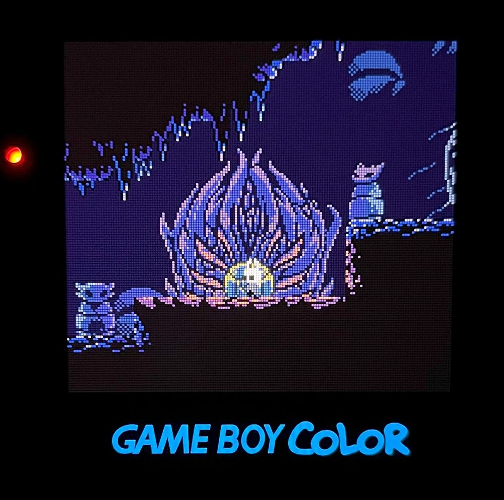 A pixel art Gameboy Color demake of Hollow Knight showing the area in King's Pass where the player gets the Fury of the Fallen charm being ran on an original Gameboy Color with an AMOLED replacement screen