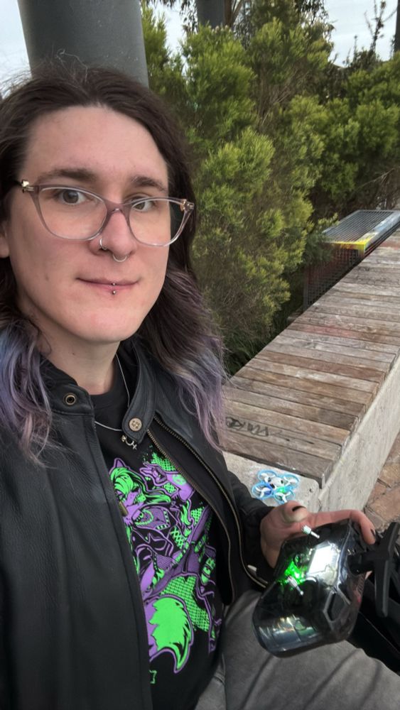 Photo of myself holding a Radiomaster, with my Meteor75 pictured beside me.