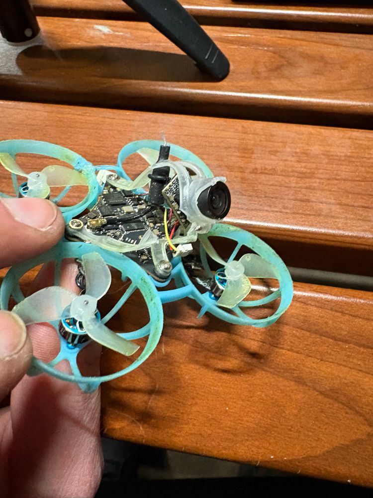 BetaFPV Air65 with a broken camera canopy, snapped composite video wire, and connector ripped off PCB.