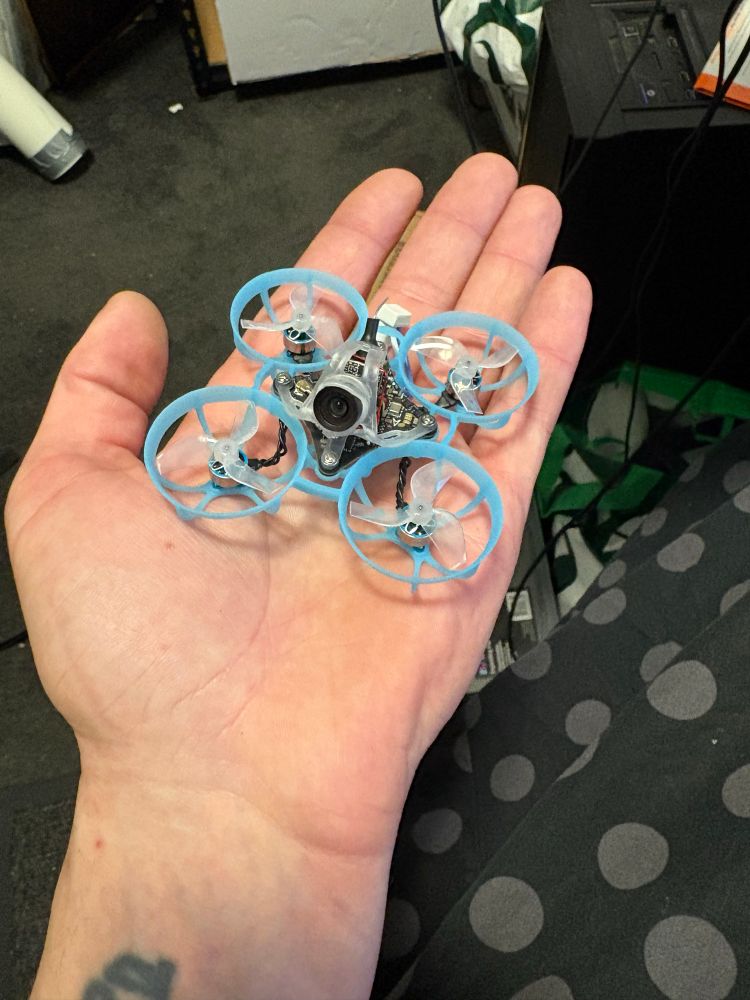 BetaFPV Air65 Micro Drone with a blue frame sitting in Rae’s hand