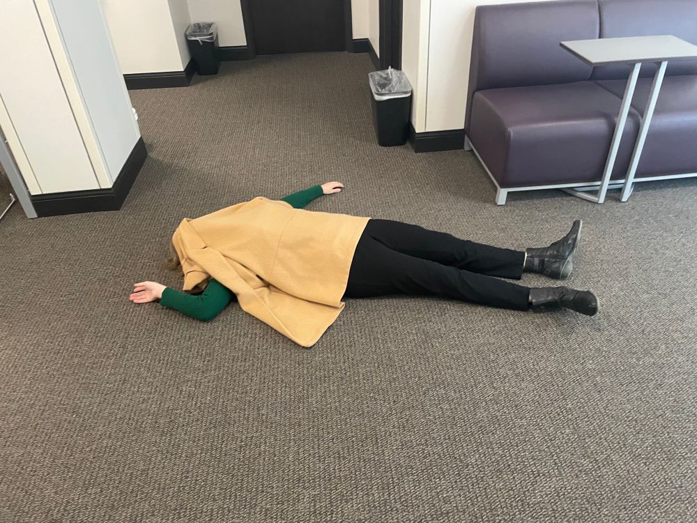 Lying on the floor with a coat over me like I’m a corpse